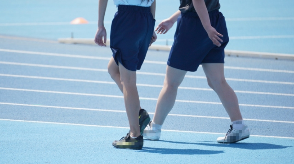 中学生が陸上競技場で練習している様子
